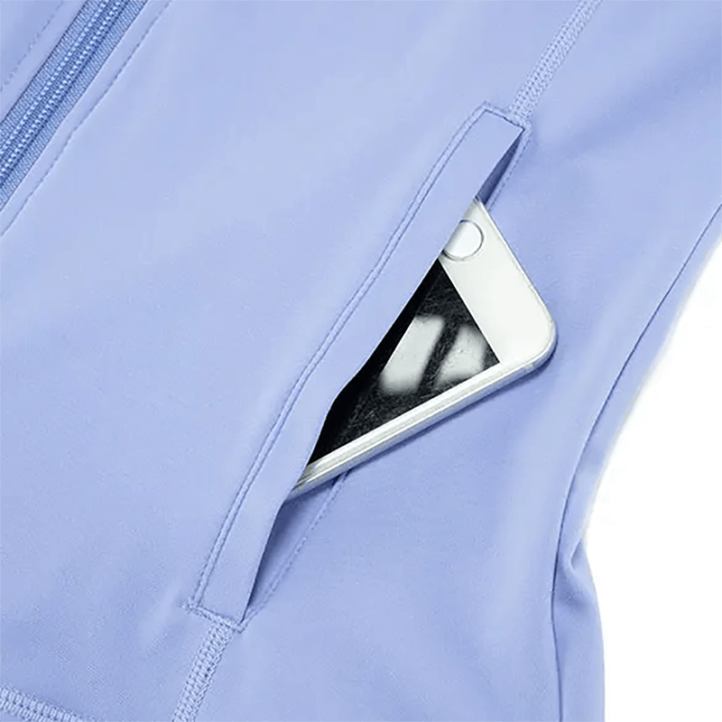 Close-up of a light blue activewear pocket with a smartphone, showcasing practical design for gym and yoga activities.